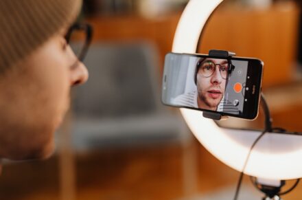 Influencer recording a video with iPhone